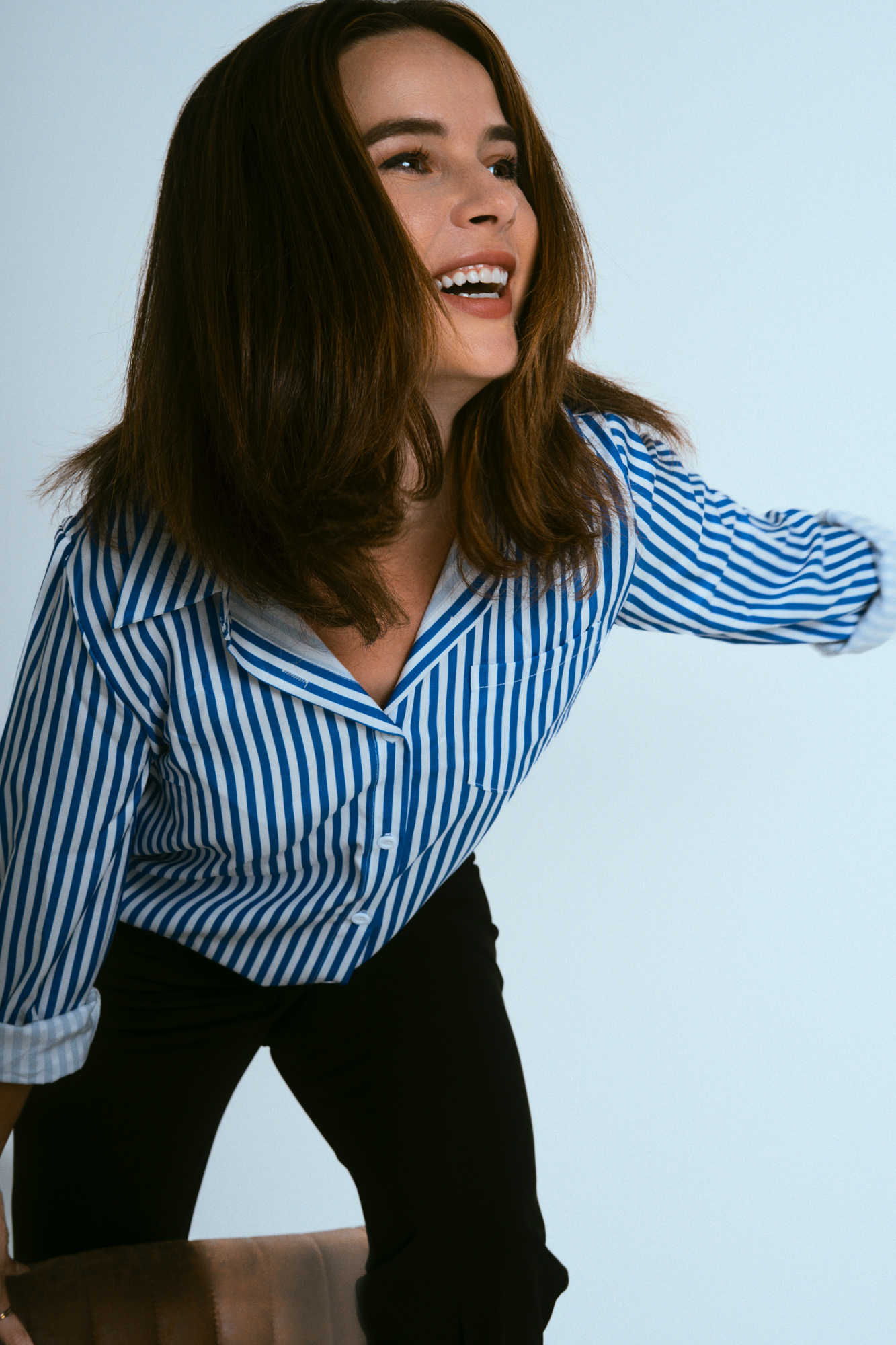 Actress Julie laughing mid-movement during a character-driven studio portrait session