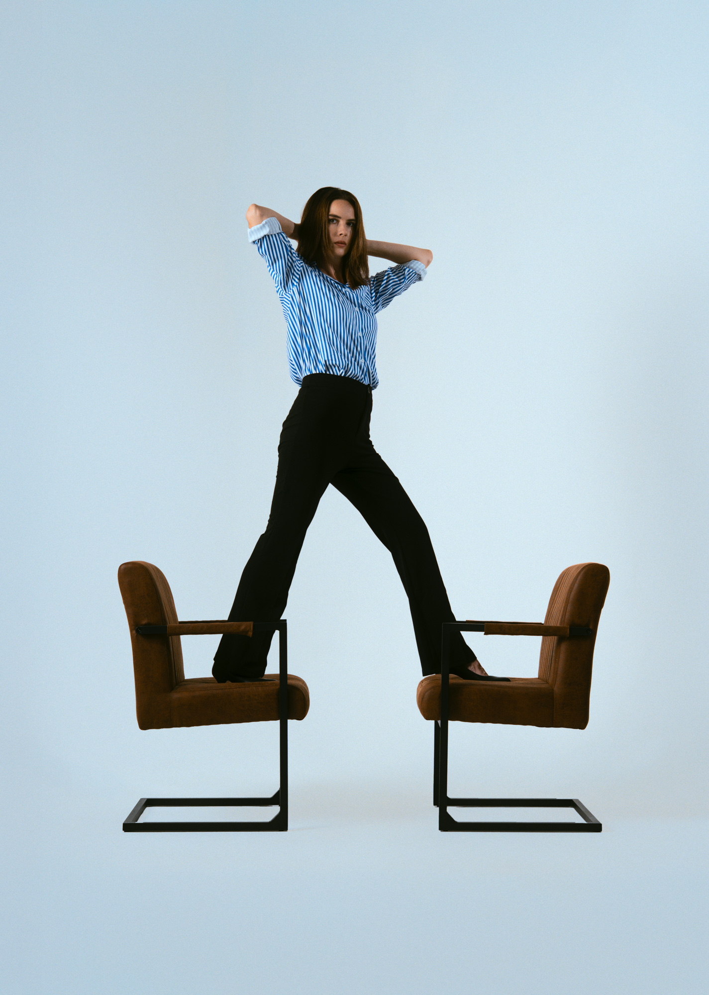 Actress Julie standing between two studio chairs