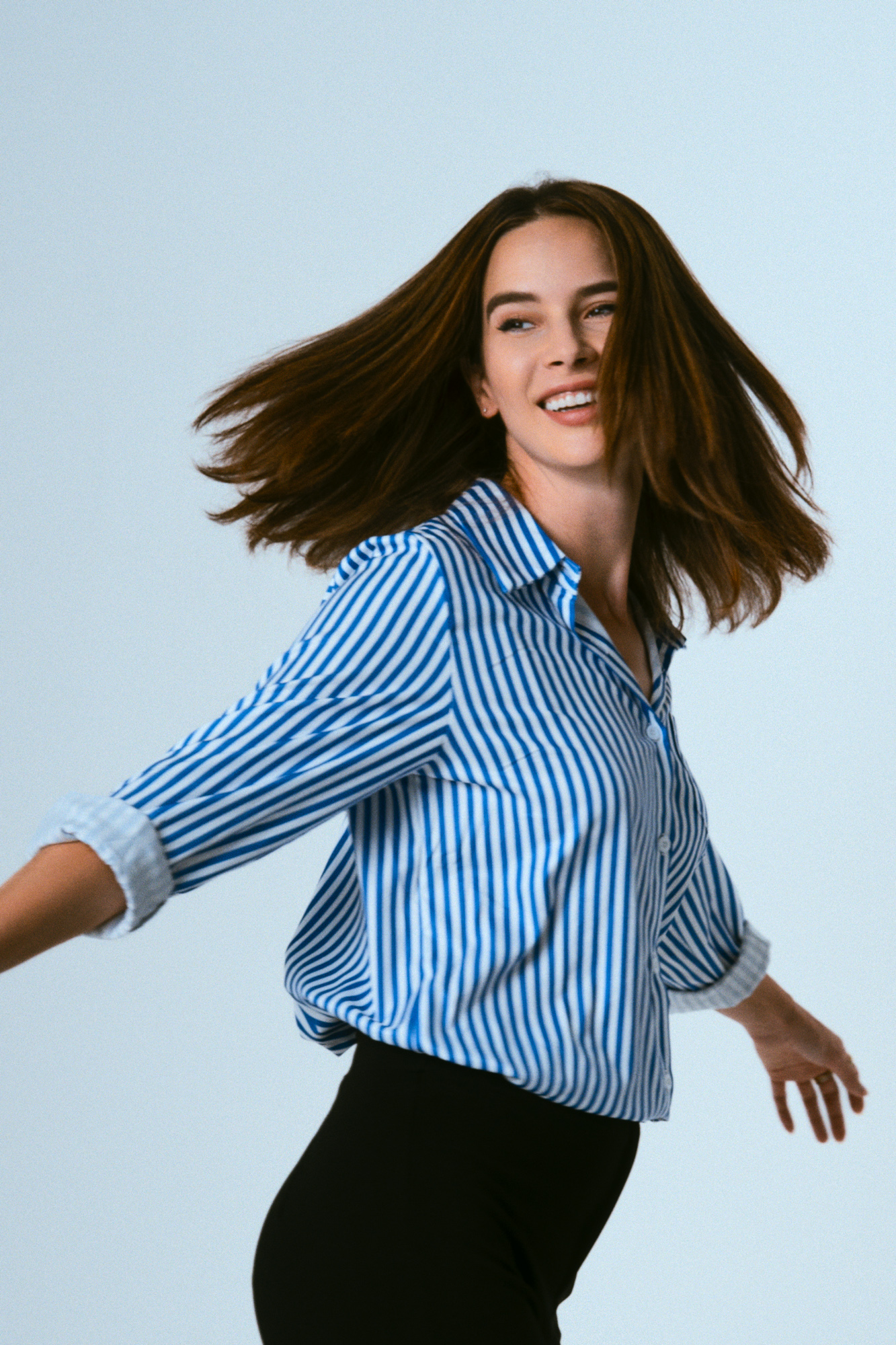 Actress Julie in a dynamic hair-flip pose